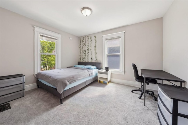 carpeted bedroom featuring baseboards