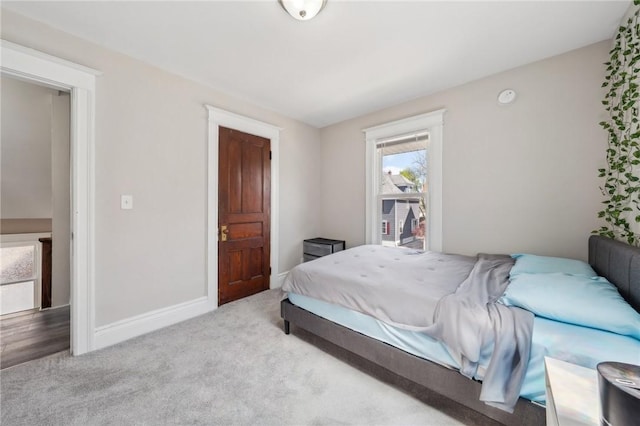 bedroom featuring baseboards and carpet floors