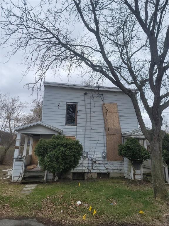 rear view of property with a gambrel roof