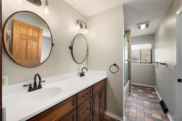 3578 S St, Kirkland, NY 13323 - bathroom featuring a sink, a shower with door, double vanity, and baseboards
