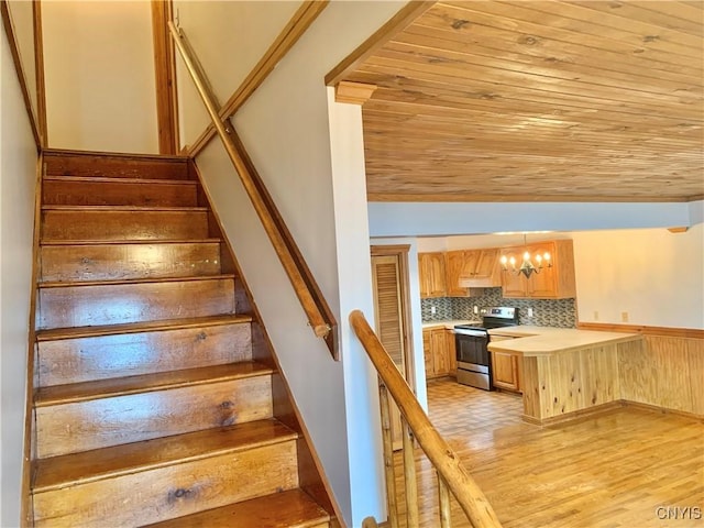 5048 State Route 28, Webb, NY 13420 - stairway featuring wooden ceiling, wood finished floors, lofted ceiling, and a notable chandelier