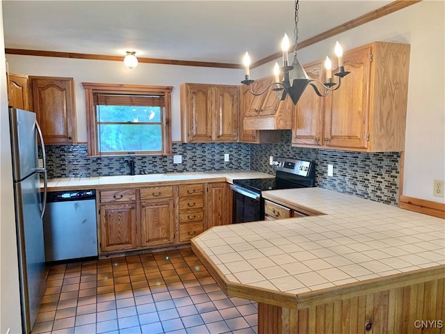 5048 State Route 28, Webb, NY 13420 - kitchen with a peninsula, ornamental molding, decorative backsplash, tile counters, and appliances with stainless steel finishes