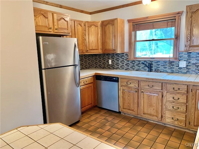 5048 State Route 28, Webb, NY 13420 - kitchen featuring a sink, tile patterned flooring, tile counters, stainless steel appliances, and tasteful backsplash