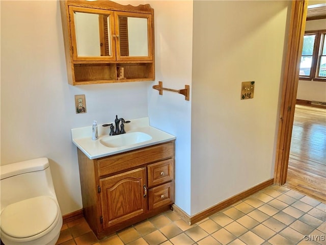 5048 State Route 28, Webb, NY 13420 - bathroom featuring vanity, toilet, and baseboards