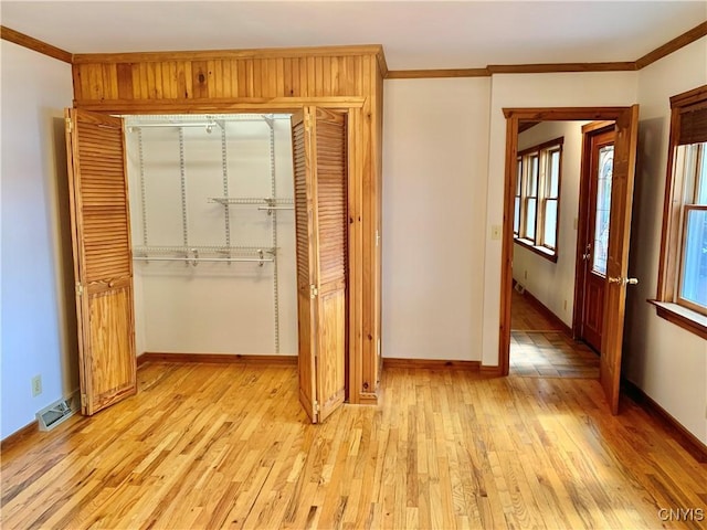 5048 State Route 28, Webb, NY 13420 - unfurnished bedroom featuring crown molding, light wood-style flooring, and a closet