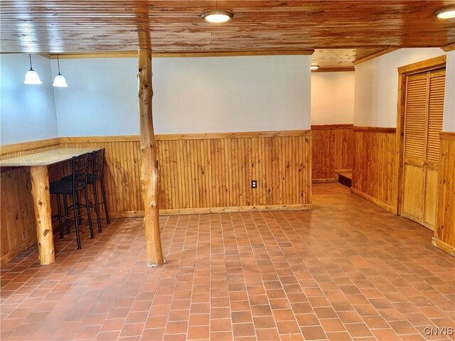 5048 State Route 28, Webb, NY 13420 - below grade area featuring a wainscoted wall, wooden ceiling, and wood walls
