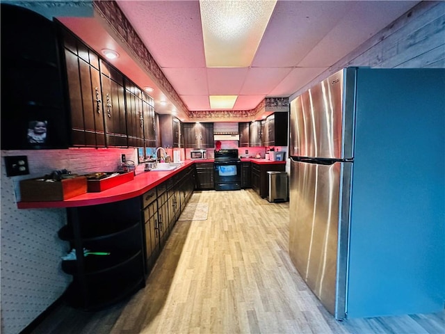 121 E William St, Bath, NY 14810 - kitchen with freestanding refrigerator, open shelves, black / electric stove, and light wood-type flooring