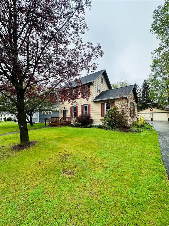 121 E William St, Bath, NY 14810 - colonial inspired home featuring a garage, an outbuilding, and a front yard