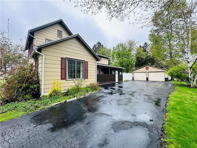 121 E William St, Bath, NY 14810 - view of front facade with a garage and an outbuilding