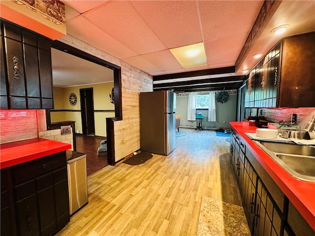 121 E William St, Bath, NY 14810 - kitchen with a sink, freestanding refrigerator, light wood-type flooring, and a drop ceiling