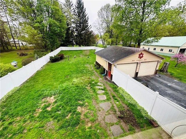 121 E William St, Bath, NY 14810 - exterior space featuring a lawn, an outbuilding, a garage, and a fenced backyard