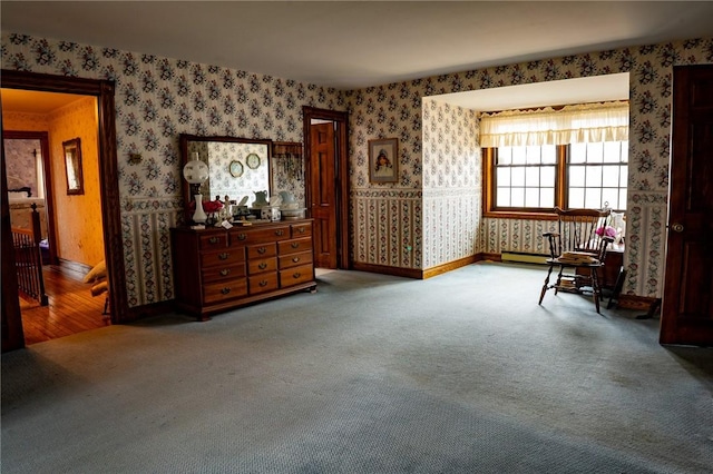 living area featuring wallpapered walls, baseboards, and carpet