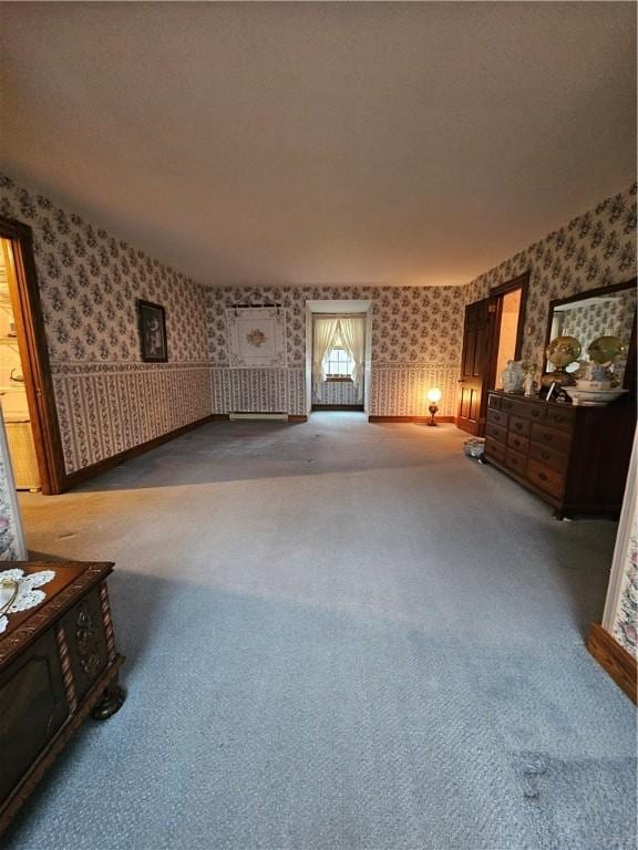 interior space with carpet floors and wallpapered walls