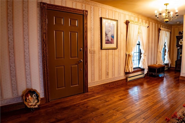 10400 Fox Ridge Rd, Corning, NY 14830 - entrance foyer with wallpapered walls, dark wood finished floors, a chandelier, and a baseboard heating unit