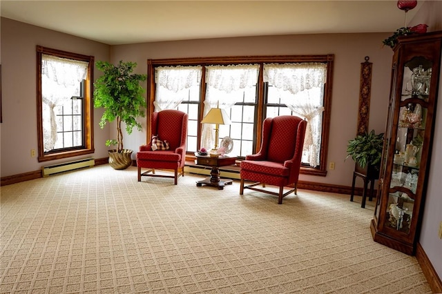 living area featuring light colored carpet, a baseboard radiator, baseboards, and baseboard heating