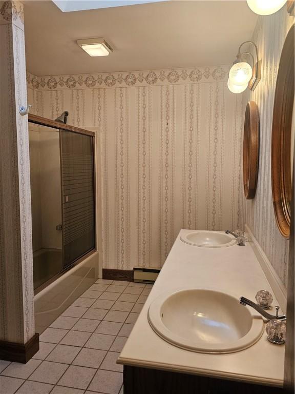 10400 Fox Ridge Rd, Corning, NY 14830 - bathroom with tile patterned flooring, shower / bath combination with glass door, wallpapered walls, double vanity, and baseboard heating