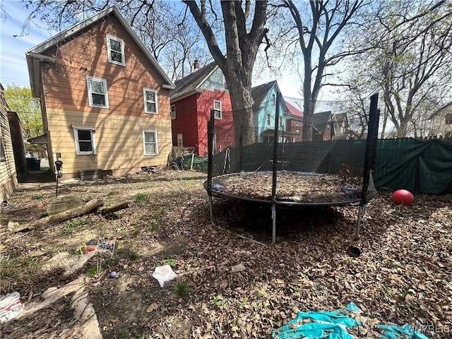 view of yard featuring central air condition unit and a trampoline
