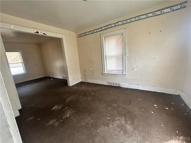 spare room featuring baseboards and visible vents