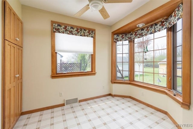 spare room with visible vents, baseboards, and a ceiling fan