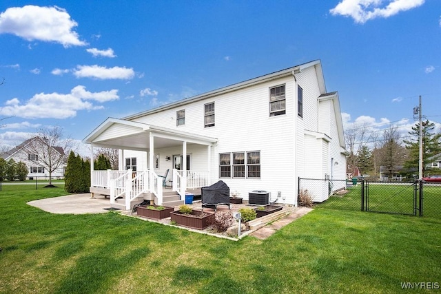 rear view of house with a yard, fence, cooling unit, a patio area, and a gate