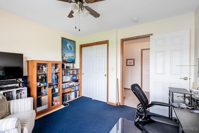 carpeted office space with ceiling fan