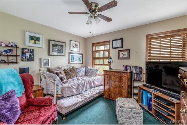 living room featuring ceiling fan and carpet