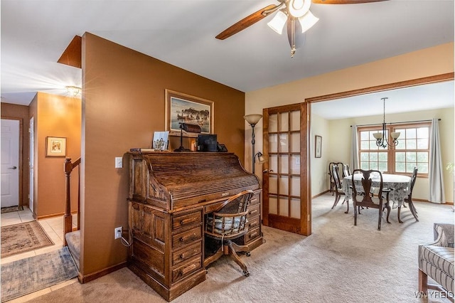 office space with baseboards, light colored carpet, and ceiling fan with notable chandelier