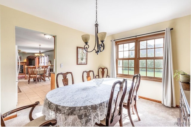dining space with baseboards and a notable chandelier