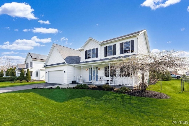 traditional-style home with covered porch, aphalt driveway, fence, an attached garage, and a front lawn