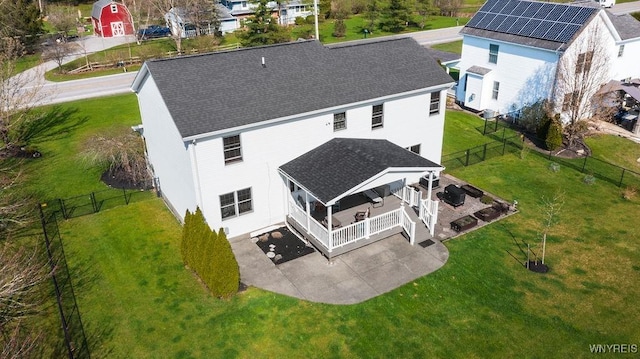 back of house with a lawn, a patio area, roof with shingles, and a fenced backyard