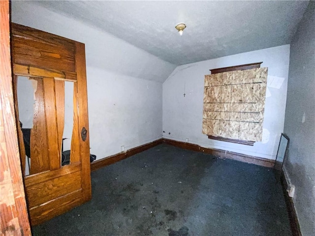 bonus room featuring baseboards, carpet floors, and vaulted ceiling