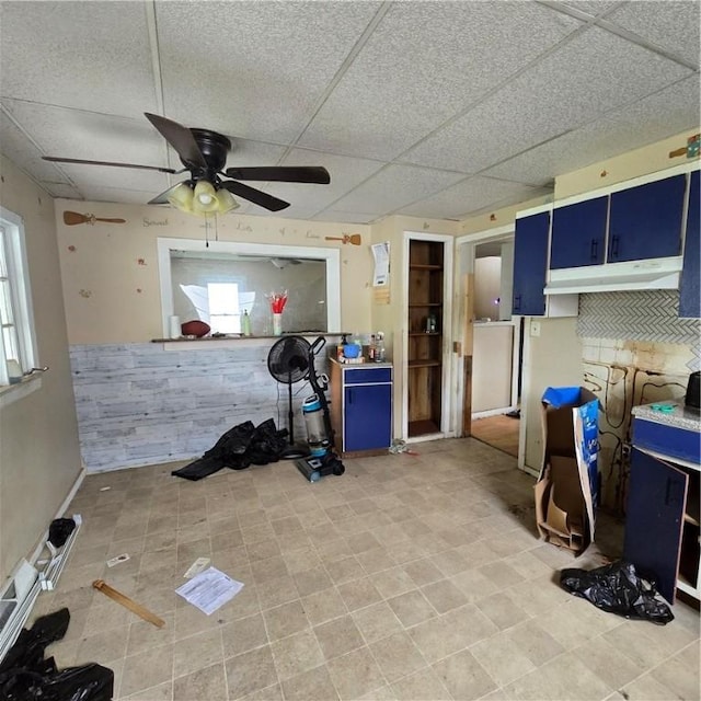 interior space featuring ceiling fan and a paneled ceiling