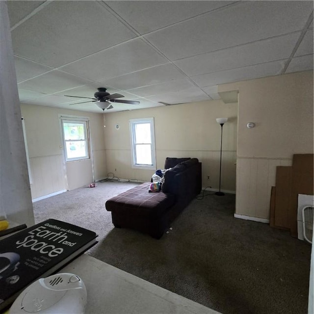 bedroom with ceiling fan, carpet, and a drop ceiling