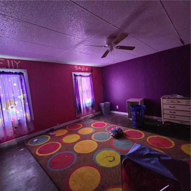 bedroom featuring a paneled ceiling, ceiling fan, and baseboards
