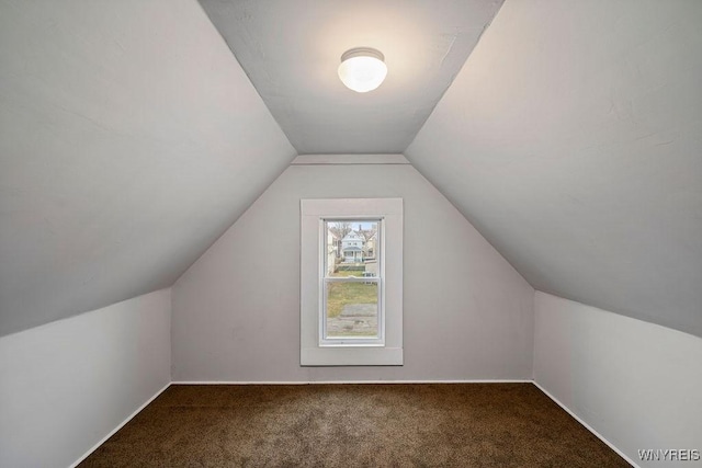 bonus room with lofted ceiling, carpet floors, and baseboards