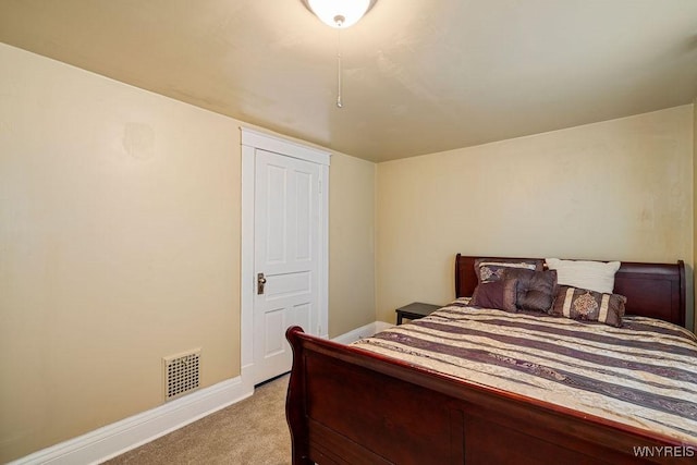 bedroom with baseboards, visible vents, and carpet