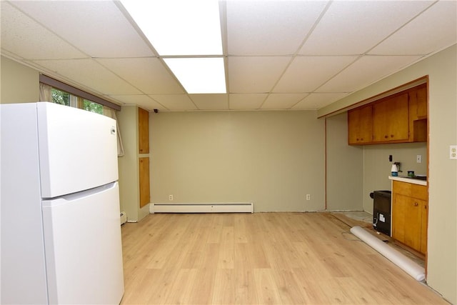 726 Robinson Hill Rd, Union, NY 13790 - kitchen featuring a drop ceiling, brown cabinets, freestanding refrigerator, light wood-type flooring, and a baseboard heating unit