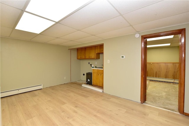 726 Robinson Hill Rd, Union, NY 13790 - unfurnished living room featuring a baseboard radiator, light wood-style flooring, and a drop ceiling