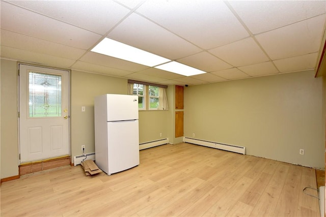 726 Robinson Hill Rd, Union, NY 13790 - basement with freestanding refrigerator, light wood-type flooring, and a baseboard heating unit