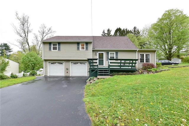 726 Robinson Hill Rd, Union, NY 13790 - split level home with a front lawn, a wooden deck, aphalt driveway, and an attached garage