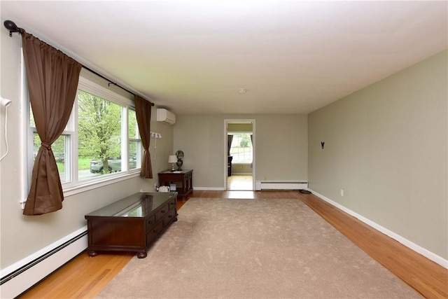 726 Robinson Hill Rd, Union, NY 13790 - empty room featuring light wood-style floors, a wall mounted AC, and a baseboard heating unit