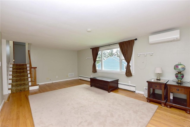 726 Robinson Hill Rd, Union, NY 13790 - living room featuring stairway, light wood-type flooring, a wall unit AC, and baseboard heating