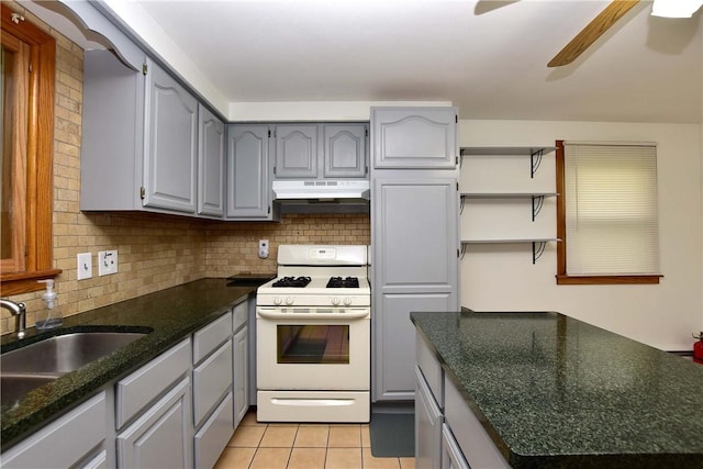 726 Robinson Hill Rd, Union, NY 13790 - kitchen featuring white range with gas stovetop, a ceiling fan, under cabinet range hood, gray cabinetry, and decorative backsplash
