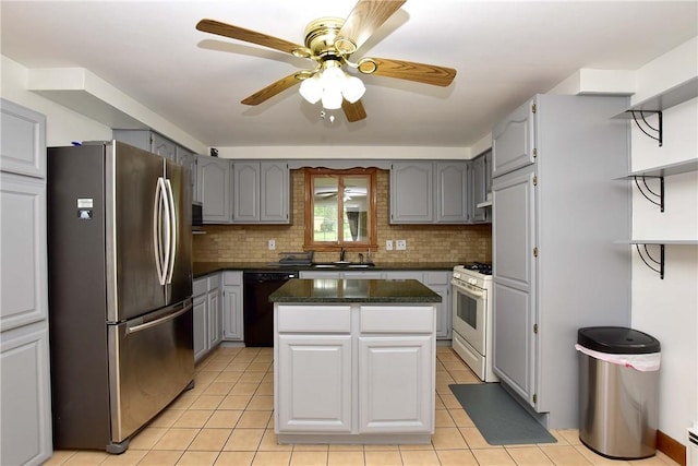726 Robinson Hill Rd, Union, NY 13790 - kitchen featuring freestanding refrigerator, black dishwasher, dark countertops, gas range gas stove, and gray cabinets