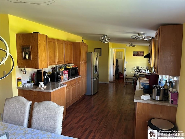 9642 S Dayton Silver Creek Rd, Villenova, NY 14062 - kitchen with stainless steel fridge, brown cabinets, dark wood-style flooring, light countertops, and black microwave