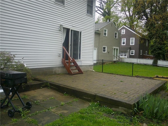 back of property featuring a yard, fence, and entry steps