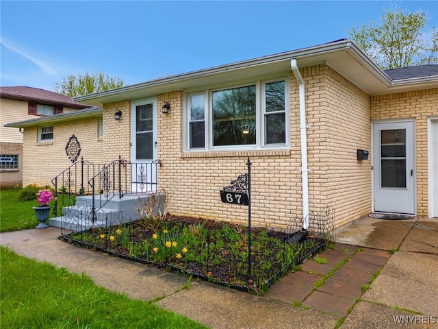 property entrance featuring brick siding