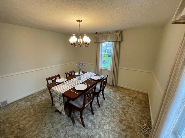 dining space featuring a textured ceiling, baseboards, visible vents, a chandelier, and carpet floors