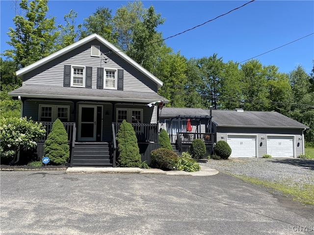 view of front of property with covered porch and a garage