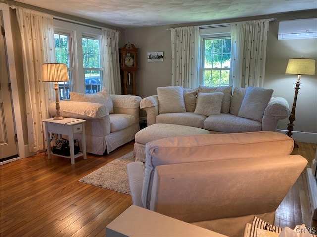 living room with a wall mounted AC and hardwood / wood-style floors